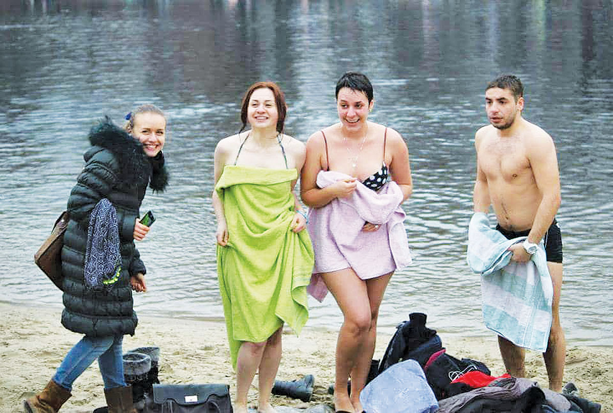 Tamara Shevchuk (second from right) and her friends stand on the bank of the Dnipro River in Kyiv's Hydropark after swimming in cold water on Jan. 19, 2015.