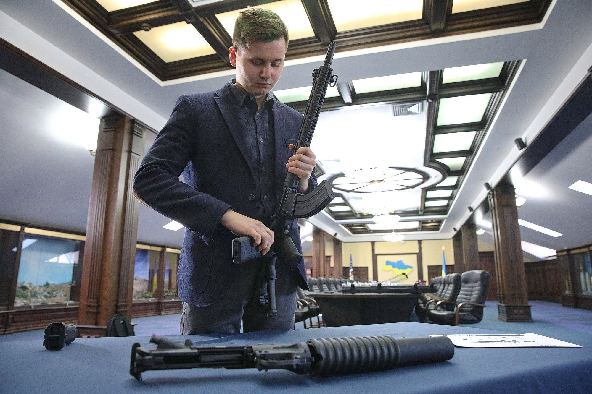 The UkrOboronServis defense company respresentative Sergiy Zhydkov dismantles an M4-WAC47 rifle in Kyiv on Jan. 24.