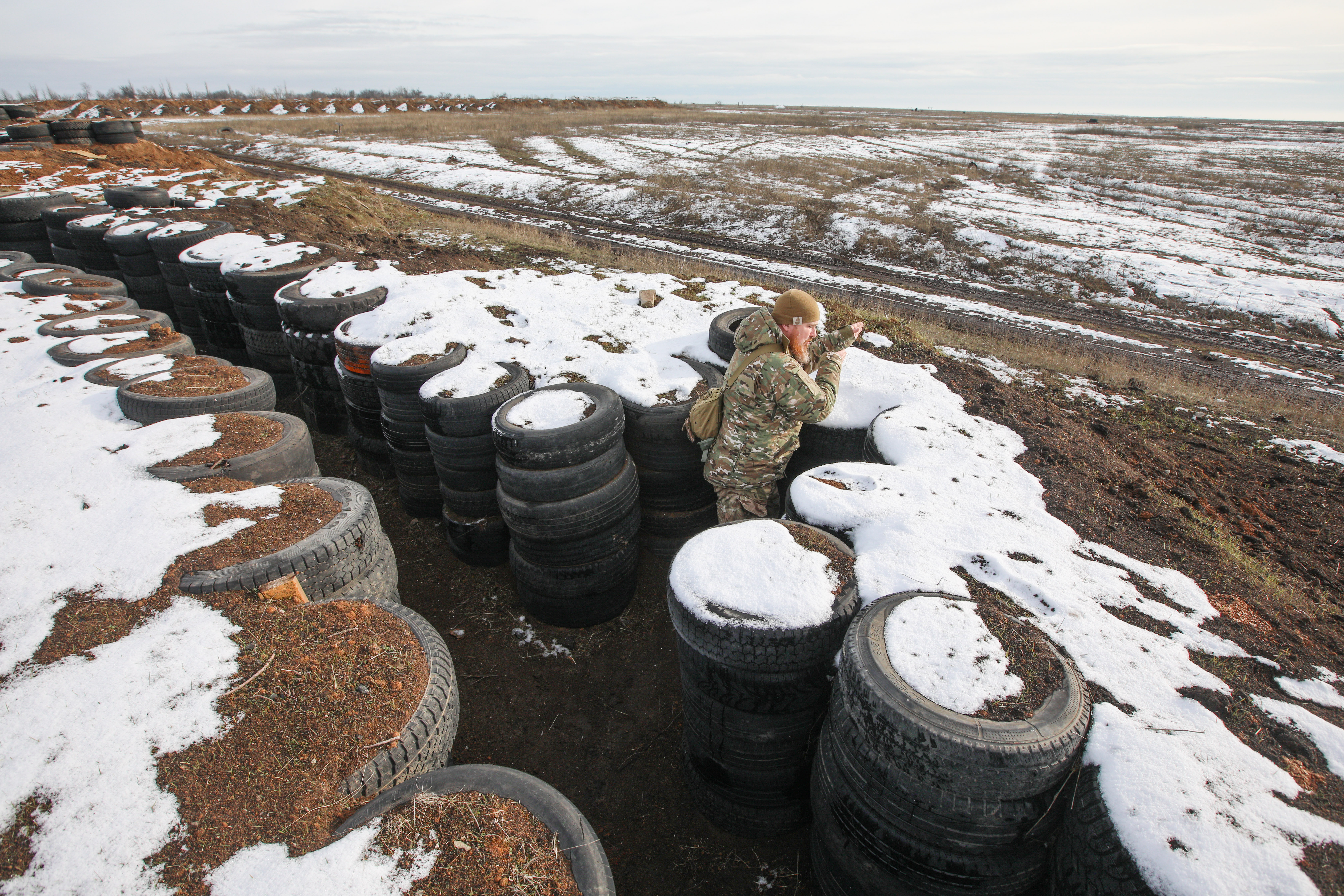 The Azov Regiment's deputy commander for special training Igor Bezogliuk (codename "Basel") demonstrates a construction that simulates a defensive combat line at a firing range near the town of Urzuf in southern Donetsk Oblast on Dec. 23. 