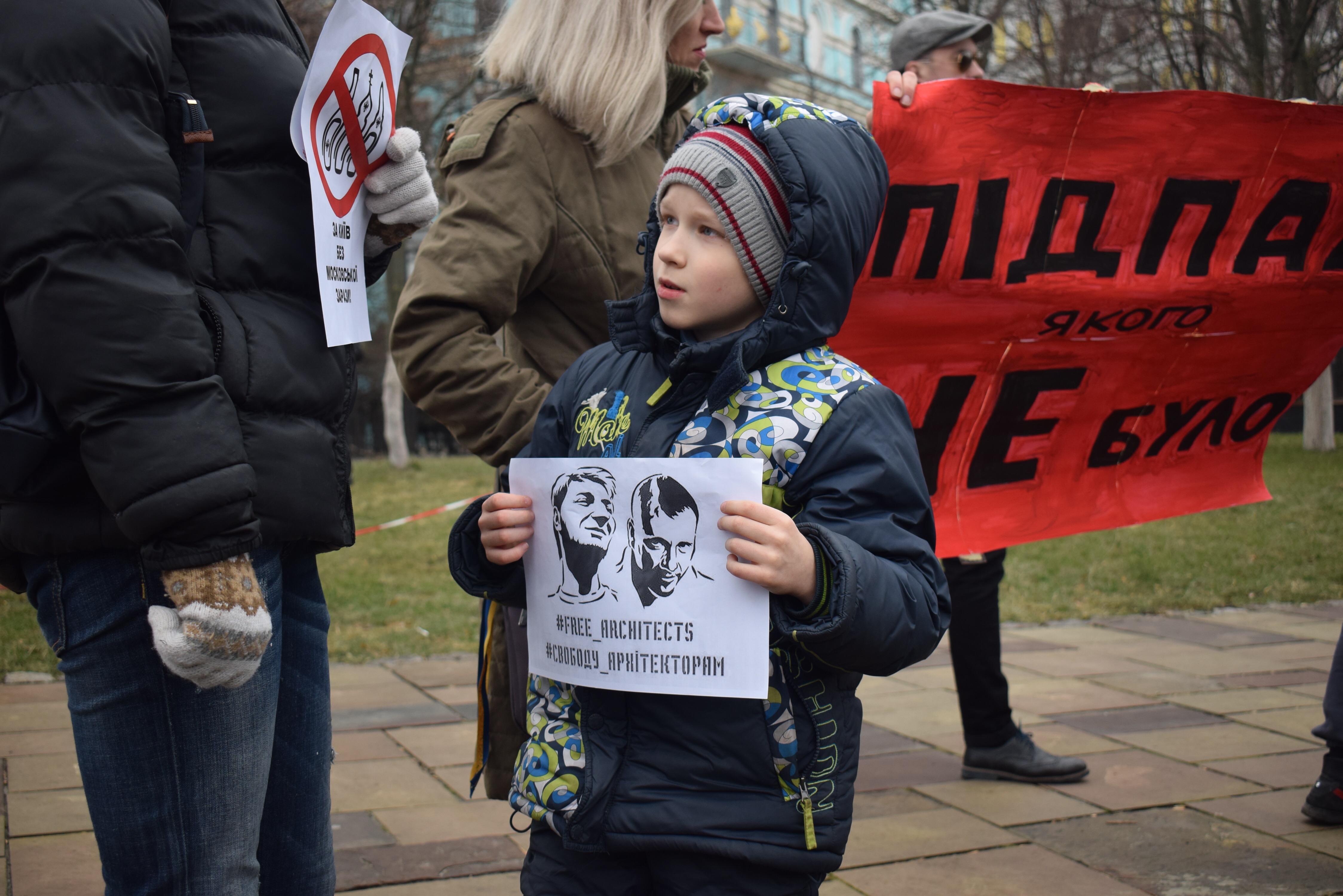 A boy holds a sign “Free architects” at the protest against the Ukrainian Orthodox Church of the Moscow Patriarchate near its chapel on Volodymyrska St. on Feb. 3. (Vlad Krasinskiy)