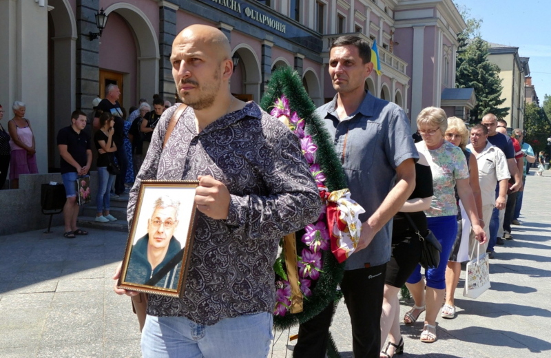 Mourners walk with a portrait of Vadym Komarov, a journalist from Cherkasy at his funeral on June 21, 2019. An unknown assailant attacked Komarov, mortally wounding him on May 4, 2019. He died on June 20.